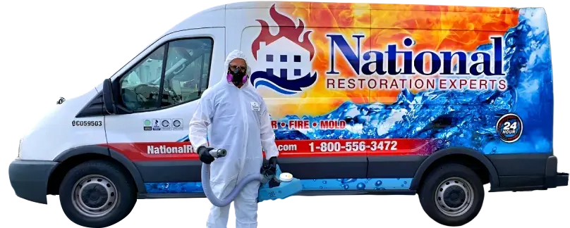 Man in hazmat suit walking away from a National Restoration Experts van
